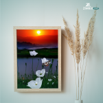 A framed image of white flowers against a beautiful sunset backdrop, showcasing vibrant colors and serene beauty.