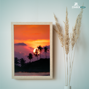 A bus parked on the beach during sunset, with vibrant colors illuminating the sky and reflecting on the water.